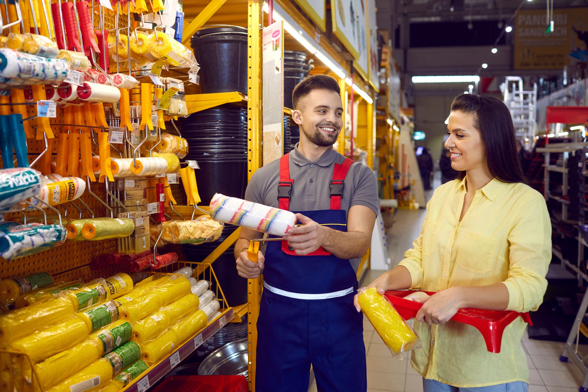 Smiling salesman consult female client in building store